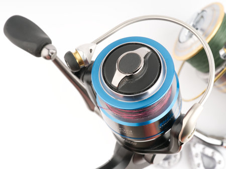 Moscow, Russia-October 16, 2022: Branded fishing reel bobbins up on a white background. Closeupのeditorial素材