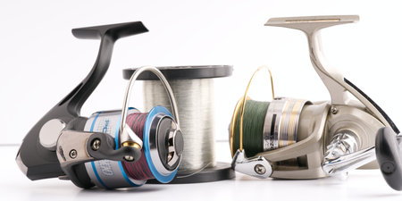 Moscow, Russia-October 16, 2022: Two branded fishing reels and a large skein with a fishing lineのeditorial素材