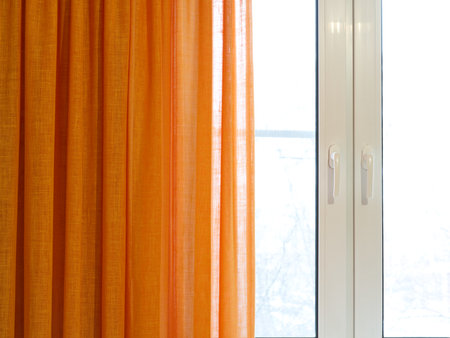 Plastic window and orange curtains. Interiorの写真素材