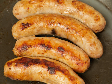 Sausages fried in a frying pan. closeup.の写真素材