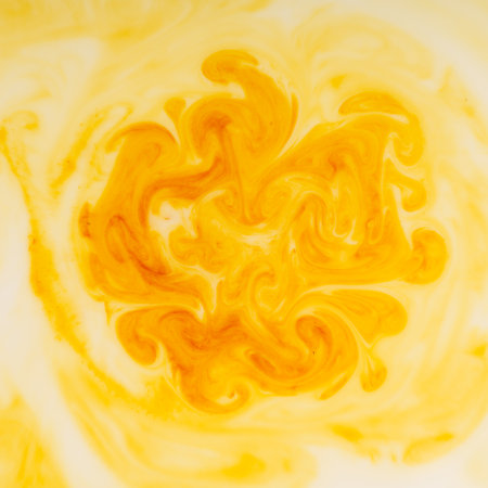 A stain of paint dissolved in a white liquid closeup. View from above. Abstractの写真素材