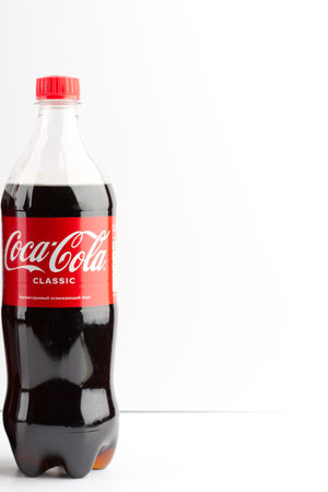 Moscow, Russia-September 16, 2022: One bottle of Coca Cola on a white background. Vertical snapshotのeditorial素材