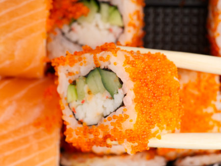 Lots of pieces of sushi and one in a chopsticks. View from above. Closeupの写真素材