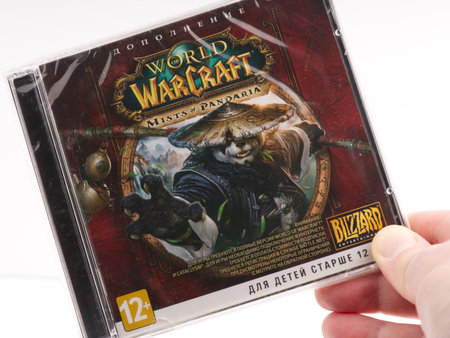 Moscow, Russia-October 16, 2022: World of warcraft expansion disc in hand on a white background. Closeのeditorial素材