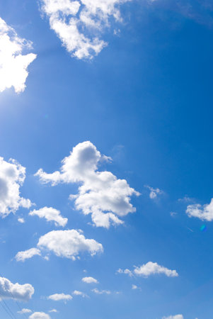Blue sky and white clouds. Summer. Vertical snapshotの写真素材
