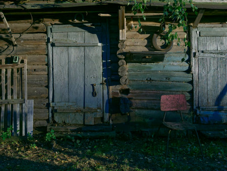 An old wooden house nearby. The door and part of the wall are visible. Built in the 50th year of the 20th century in Russia.の写真素材