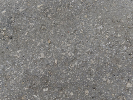 The texture of the gray cement wall with stones frozen inside. Close.の写真素材