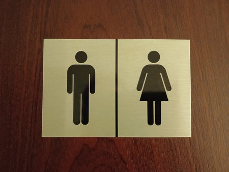 A sign for men's and women's toilets. Close.の写真素材