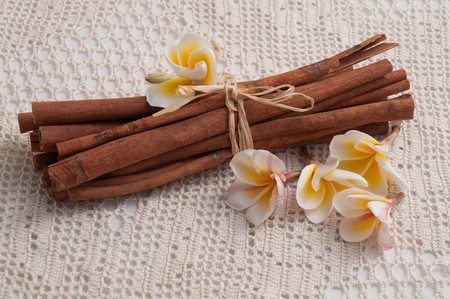 Bunch of cinnamon sticks with almond on the white tablecloth .の写真素材
