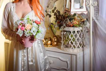 Flower girl at a wedding holding a basket of flowers.の写真素材