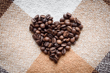 Love, coffee lover, made with love concepts. Heart with letters creating I Love You made of fried coffee beans on grunge canvas.の写真素材