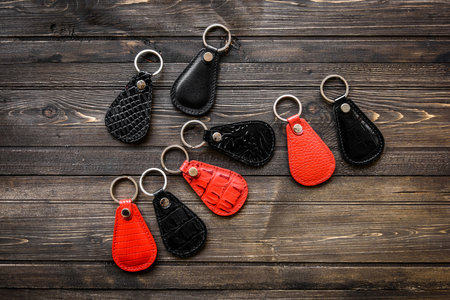 Keys attached to leather keychain , on darken wooden background