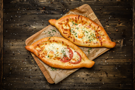 Two Georgian khachapuri close-up on the table. horizontal view from aboveの写真素材