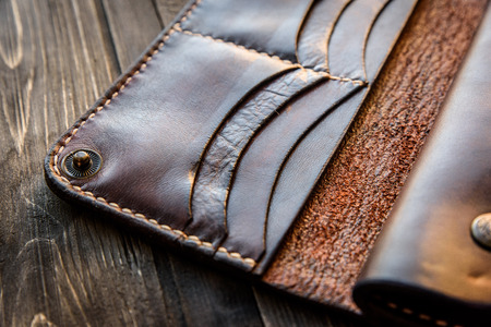 Brown leather wallet on wooden table, Old leather wallet.の写真素材
