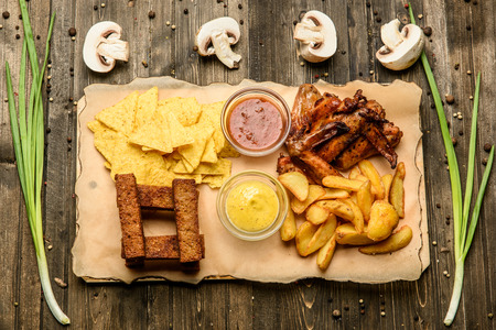 a wide selection of snacks for beer on a parchment top view.の写真素材