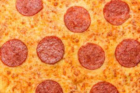 Appetizing background pepperoni pizza closeup filling the frame.の写真素材