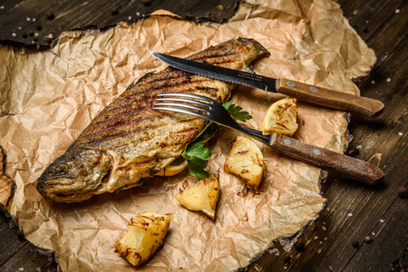 Baked mackerel with lemon on baking paperの写真素材