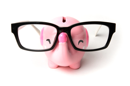 Pink elephant piggy bank with glasses isolated on a white backgroundの写真素材