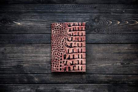 Brown leather wallet on wooden background top viewの写真素材