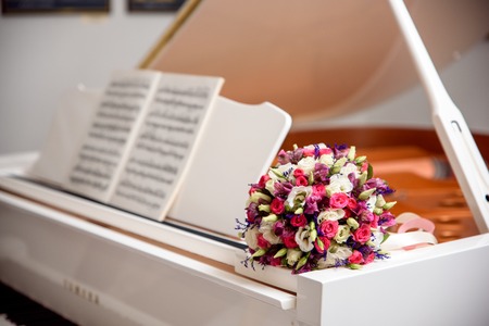 wedding bouquet on the white piano close upの写真素材
