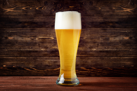 Glass of light beer on a pub with bokeh backgroundの写真素材