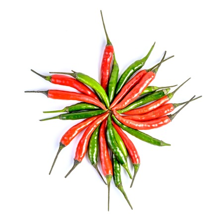 Close-up of some red and green chillies mixed isolatedの写真素材