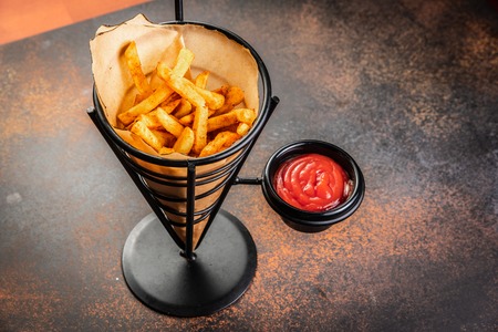 French fries in a paper bag with sauces. Top view.の写真素材