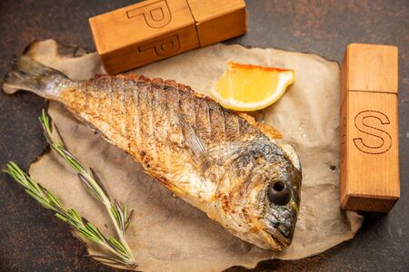 Grilled dorado fish on parchmentの写真素材