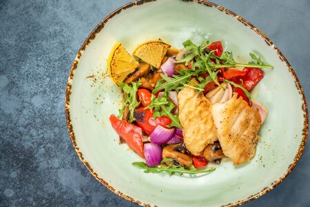 Pieces of fried fish with vegetables. Top viewの写真素材