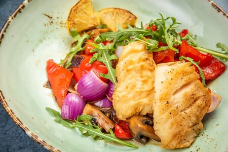 Pieces of fried fish with vegetables. Top viewの写真素材