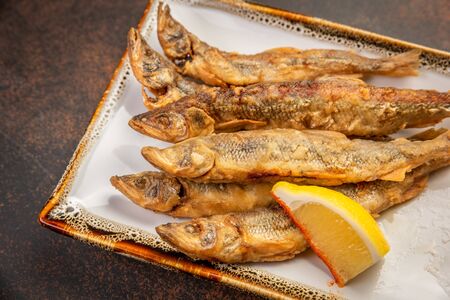 Crispy deep-fried small fish with lemonの写真素材