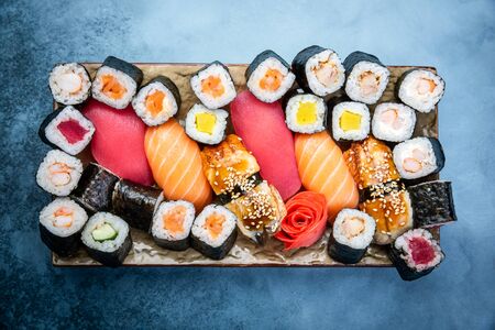 Top view of traditional delicious Japanese seafood served on wooden board on dark marble backgroundの写真素材