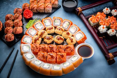 From above composition of various sushi rolls, green tea and chopsticks on marble backgroundの写真素材
