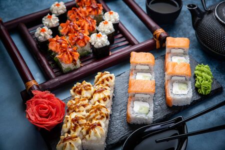 From above composition of various sushi rolls, green tea and chopsticks on marble backgroundの写真素材