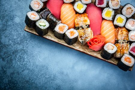 Top view of traditional delicious Japanese seafood served on wooden board on dark marble backgroundの写真素材