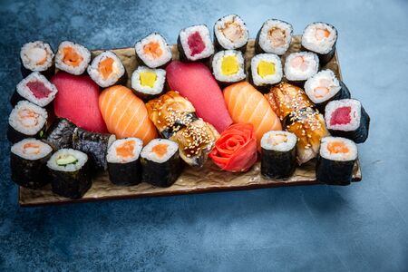 Top view of traditional delicious Japanese seafood served on wooden board on dark marble backgroundの写真素材