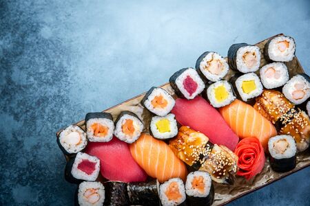 Top view of traditional delicious Japanese seafood served on wooden board on dark marble backgroundの写真素材