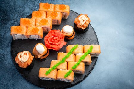 From above composition of delicious Japanese rolls topped with wasabi arranged on dark marble backgroundの写真素材