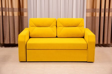 Modern yellow sofa and chair in room interior at home or hotelの写真素材