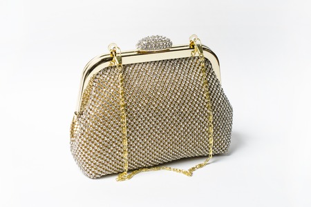 gold clutch with diamonds on a white backgroundの写真素材