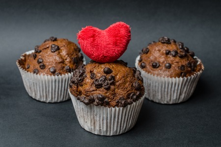 chocolate muffins with heart  on a dark backgroundの写真素材