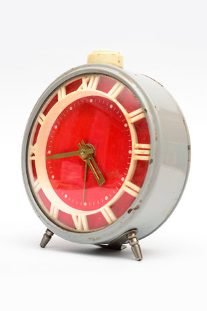 Old mechanical alarm clock on white background