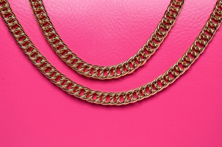 gold chain on a pink backgroundの写真素材