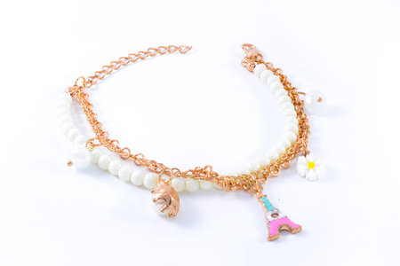 bracelet with pearls and pendants isolated on whiteの写真素材