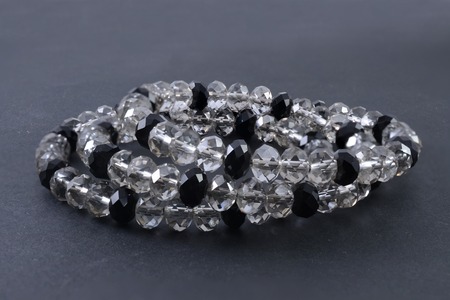 bracelet made of transparent beads isolated on blackの写真素材