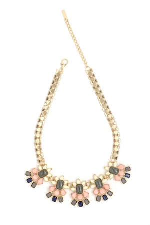 gold necklace with pink stones isolated on whiteの写真素材