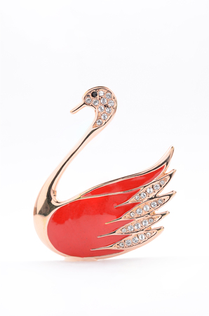 brooch in the shape of a swan on a white backgroundの写真素材