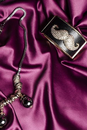 necklace with black beads and bracelet  on silk backgroundの写真素材