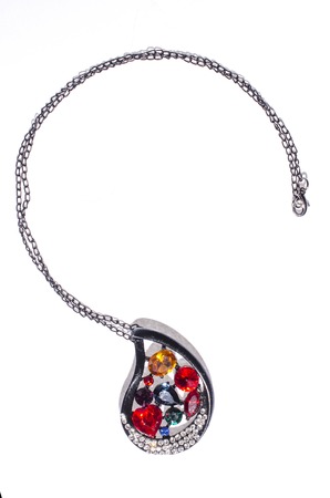 black pendant with colored gems on a white backgroundの写真素材