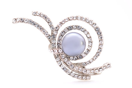 silver brooch on a white backgroundの写真素材
